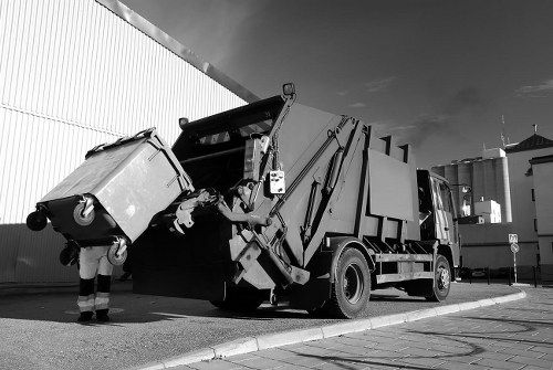 Local waste removal team sorting recyclable materials during a collection