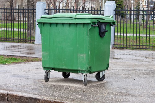 Waste collection team loading household rubbish into a vehicle