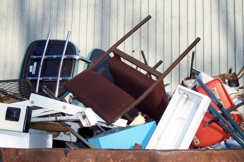 Waste removal team collecting an old mattress from a residential property